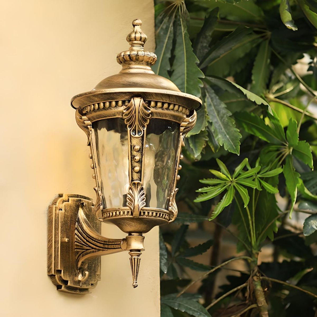Outdoor Wall Sconce with Antique Brass Finish and Textured Glass Lantern Design - Image 1